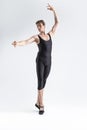 Caucasian Male Ballet Dancer Flexible Athletic Man Posing in Black Tights in Ballanced Dance Pose With Hands Lifted