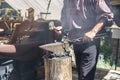 Caucasian male blacksmith forges iron in an anvil. Royalty Free Stock Photo