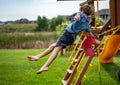 Caucasian male boy jumping from a swing set in midair falling Royalty Free Stock Photo