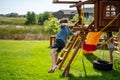 Caucasian male boy jumping from a swing set in midair falling Royalty Free Stock Photo