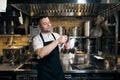 Caucasian male chef sharpening knife with sharpener on kitchen in restaurant Royalty Free Stock Photo