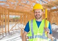 Caucasian Male Contractor With Hard Hat, Level and Safety Vest At Construction Site