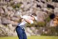 Caucasian male golfer playing a shot on the fairway on a golf course in South Africa. Royalty Free Stock Photo