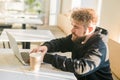 Close-up male guy portrait resting in coffee shop chatting in social networks skilled freelancer enjoying remote job Royalty Free Stock Photo