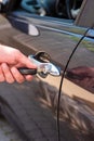 Caucasian male hand holding car keys opening the metal door lock of the vehicle Royalty Free Stock Photo