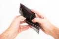 Caucasian male hand holding an empty open leather wallet close up shot isolated against bright white background Royalty Free Stock Photo