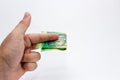 A Caucasian male hand holding a 10 Rand South African note. This image has a plain background