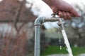 Caucasian male hand opens the garden water tap Royalty Free Stock Photo