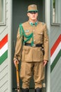A caucasian male Hungarian guard in beige uniform and rifle who stands guard near Buda Castle in Budapest.