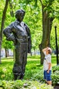 A caucasian male looking at the monument statue of Felix Leclerc