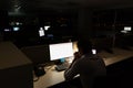 Caucasian male programmer sitting at desk, using computer with copy space on screen Royalty Free Stock Photo