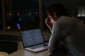Caucasian male programmer sitting at desk, using laptop with coding on screen Royalty Free Stock Photo