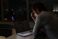 Caucasian male programmer sitting at desk, using laptop with coding on screen Royalty Free Stock Photo