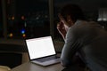 Caucasian male programmer sitting at desk, using laptop with coding on screen Royalty Free Stock Photo