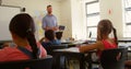 Caucasian male schoolteacher using digital tablet while teaching in classroom 4k