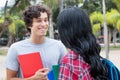 Caucasian male student talking with native latin american girlfriend Royalty Free Stock Photo