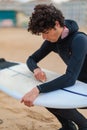 Caucasian male surfer getting ready to go surfing in the ocean