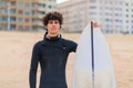 Caucasian male surfer getting ready to go surfing in the ocean