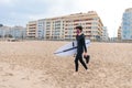 Caucasian male surfer getting ready to go surfing in the ocean