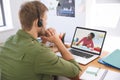 Caucasian male teacher using laptop and phone headset on video call with schoolboy learning from hom Royalty Free Stock Photo