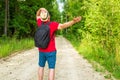 Caucasian male tourist in forest with arms wide open. Copy space.Man backpacker arms outstretched in forest.Summer day Royalty Free Stock Photo