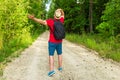 Caucasian male tourist in forest with arms wide open. Copy space.Man backpacker arms outstretched in forest.Summer day Royalty Free Stock Photo