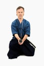 Caucasian male training Iaido, japanese sword sport. Sitting position.