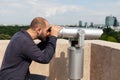 Caucasian male wathching through binoculars telescope