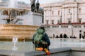 a person with a backpack is sitting in front of the water fountain