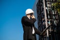 Caucasian male worker at a construction site. Architectural design is holding a laptop at a construction site, checking plans.