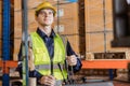 Caucasian male worker working in warehouse goods store. inventory staff moving producs pallet shipping management with folk lift