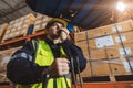 Caucasian male worker working in warehouse goods store. inventory staff moving producs pallet shipping management with folk lift