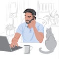 Caucasian man with beard and dark hair working from home on laptop. Having a phone call. Cat and coffee on table
