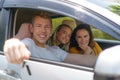 Caucasian man buying new or rent car and showing the key, sitting in car Royalty Free Stock Photo