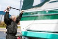 Caucasian man cleaning boat hull