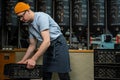 Caucasian man coffee shop worker gets new batch of coffee packages in boxes on roasting factory.