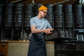 Caucasian man coffee shop worker gets new batch of coffee packages in boxes on roasting factory.