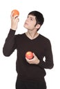 Caucasian man comparing apple to orange