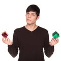 Caucasian man comparing green present to red