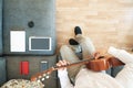 Caucasian man composing music playing a Spanish guitar in the living room. Overhead shot from above and empty copy space Royalty Free Stock Photo