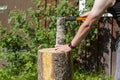 Caucasian man cutting firewood outdoors Royalty Free Stock Photo