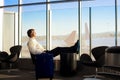 Caucasian businessman sleeping in airport terminal, planes in ba Royalty Free Stock Photo