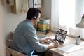 Caucasian man in earphones talk on video call with colleagues Royalty Free Stock Photo