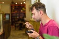 Caucasian man eating tiramisu ice cream in a cafe, copy space Royalty Free Stock Photo