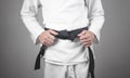 Caucasian man fixing his black belt. Karate Royalty Free Stock Photo