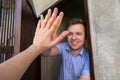 Caucasian man giving five to his neighbor. Royalty Free Stock Photo