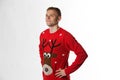 Caucasian man with hand on hips whilst wearing a christmas jumper looking away from camera Royalty Free Stock Photo