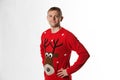 Caucasian man with hand on hips whilst wearing a christmas jumper looking to camera Royalty Free Stock Photo