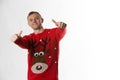 Caucasian man with hand on hips whilst wearing a christmas jumper looking to camera Royalty Free Stock Photo