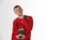 Caucasian man with hand on hips whilst wearing a christmas jumperthinking Royalty Free Stock Photo